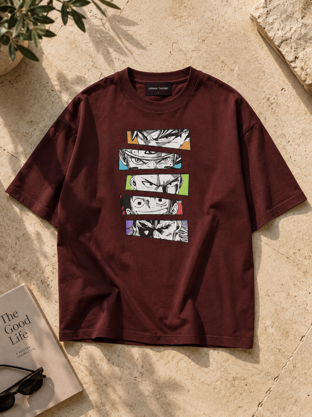 Burgundy/Maroon oversized T-shirt featuring five stacked black-and-white manga-style eye illustrations with colourful accent panels.