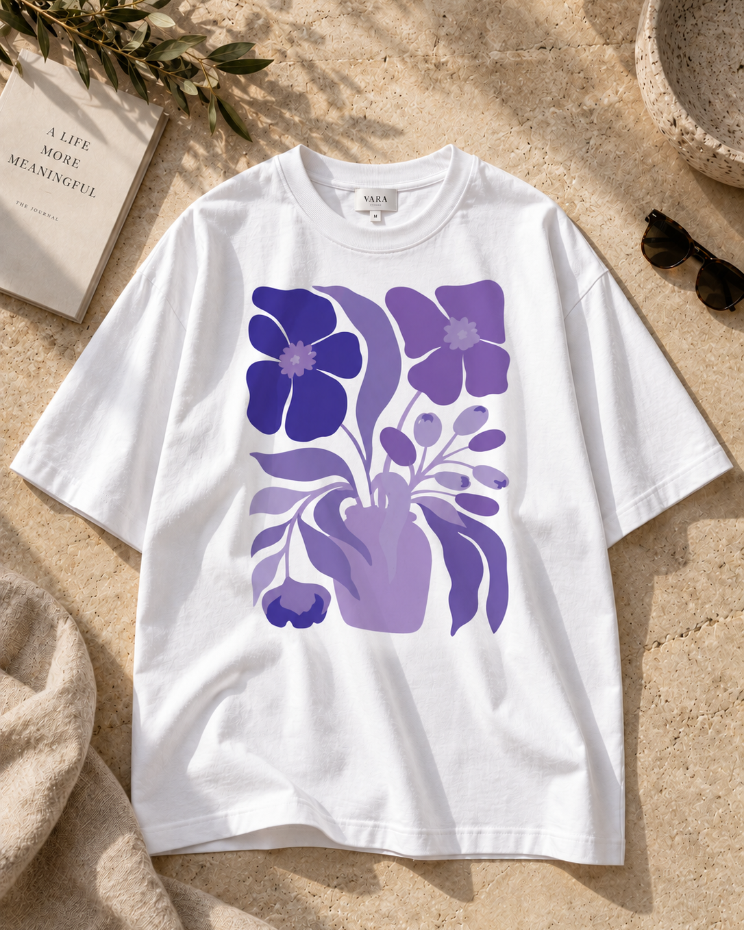 Purple and lavender flower illustration printed on a white graphic T-shirt