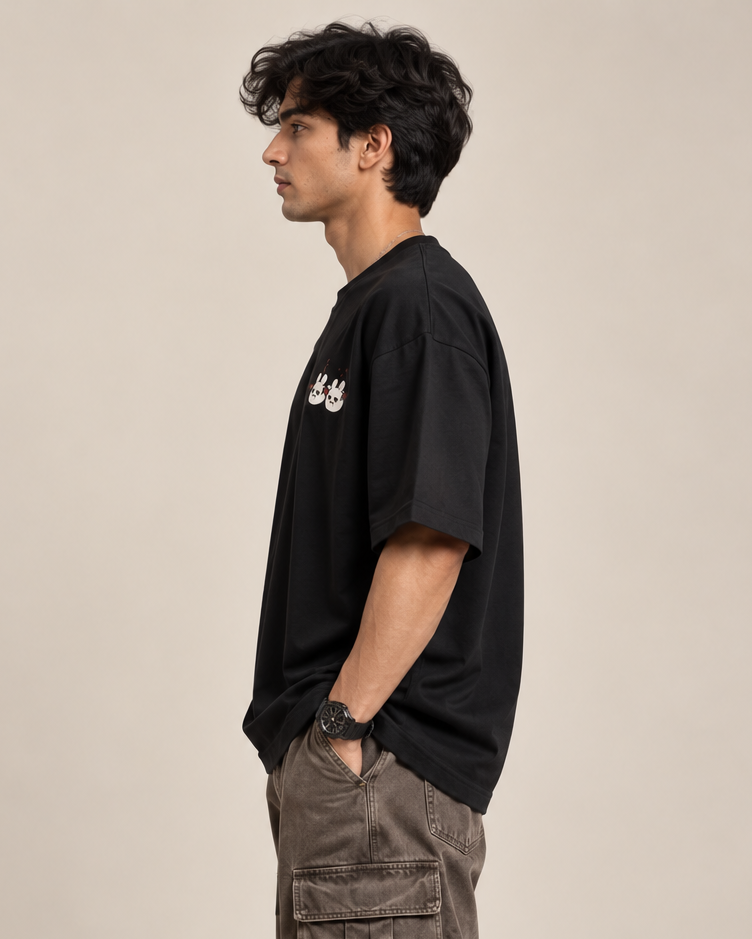 Black oversized T-shirt with a small cute ghost and bunny graphic paired with baggy pants