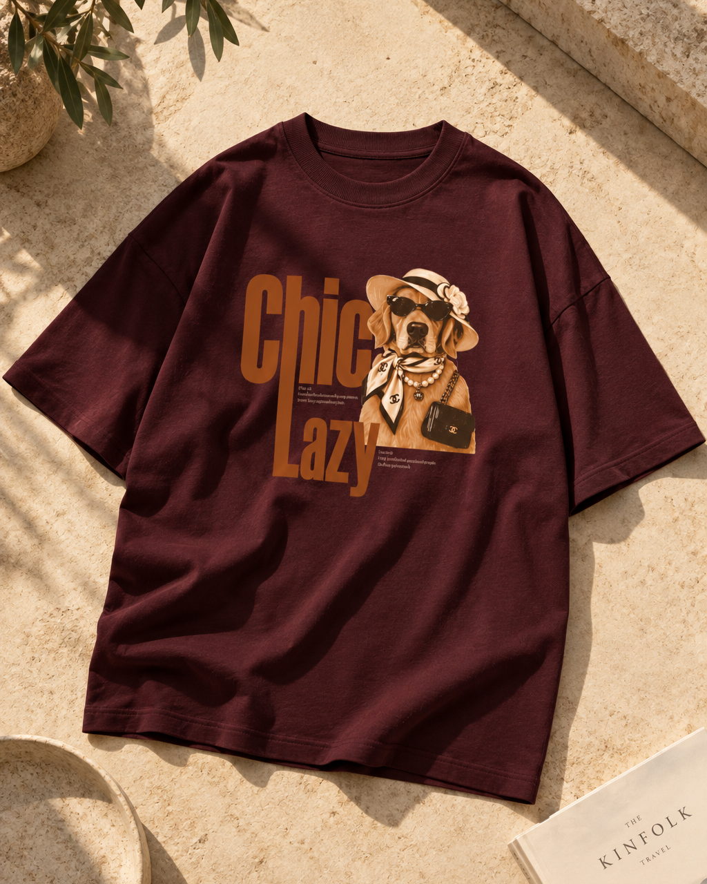 Burgundy/Maroon oversized graphic T-shirt featuring a chic Golden Retriever illustration with sunglasses, hat, pearls and retro “Chic Lazy” typography.