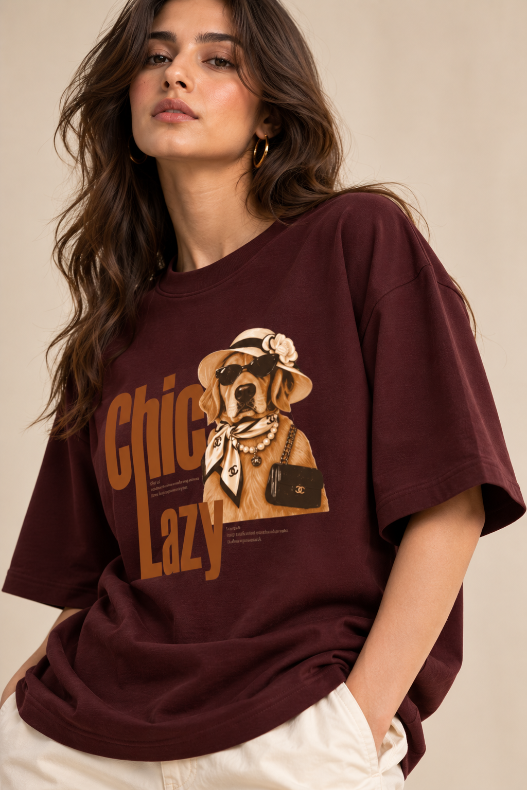 Burgundy oversized graphic T-shirt featuring a chic Golden Retriever illustration with sunglasses, hat, pearls and retro “Chic Lazy” typography.