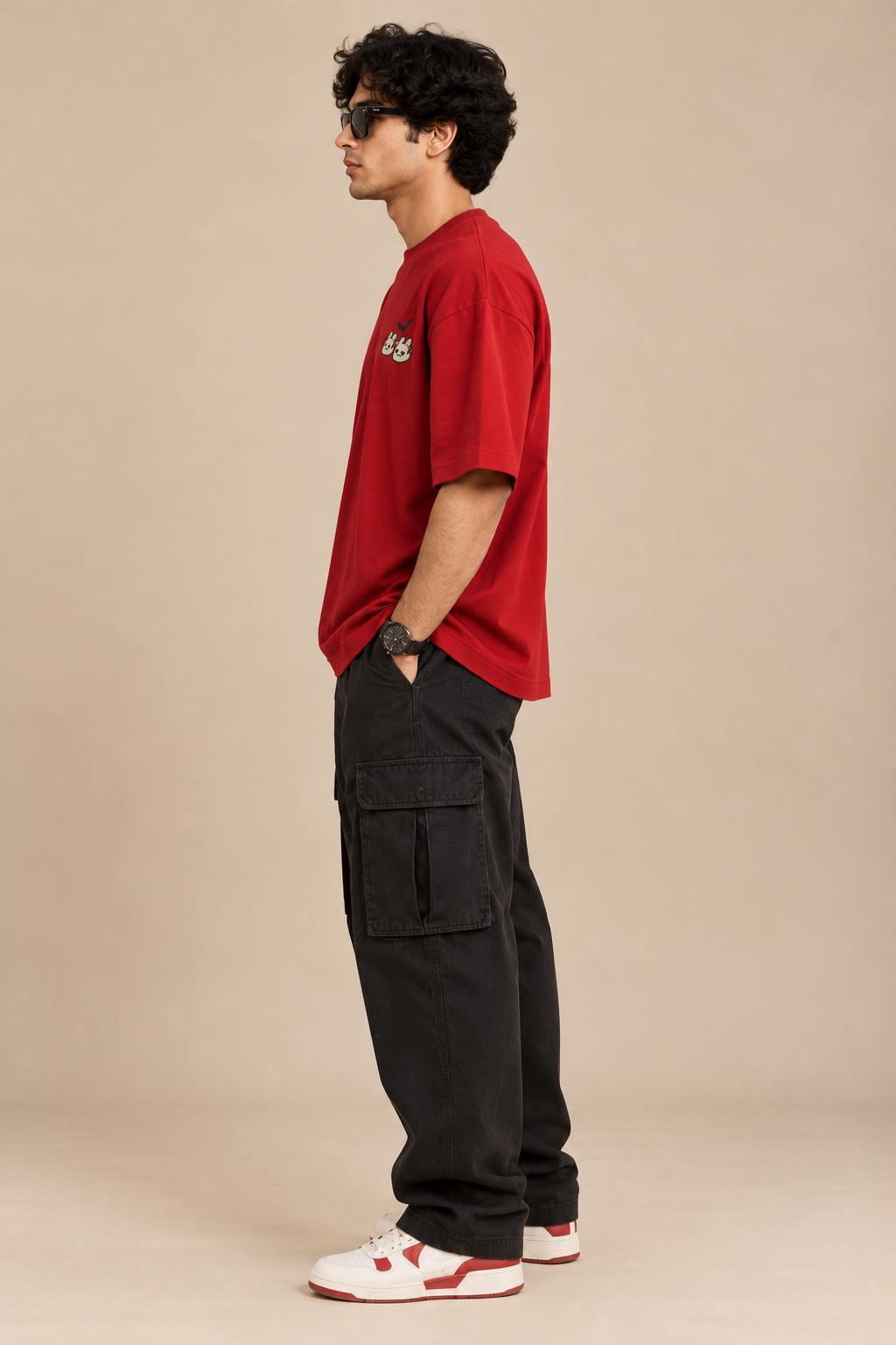 Red oversized Halloween T-shirt with a small cute ghost and bunny graphic and a black bat on the chest styled with baggy pants