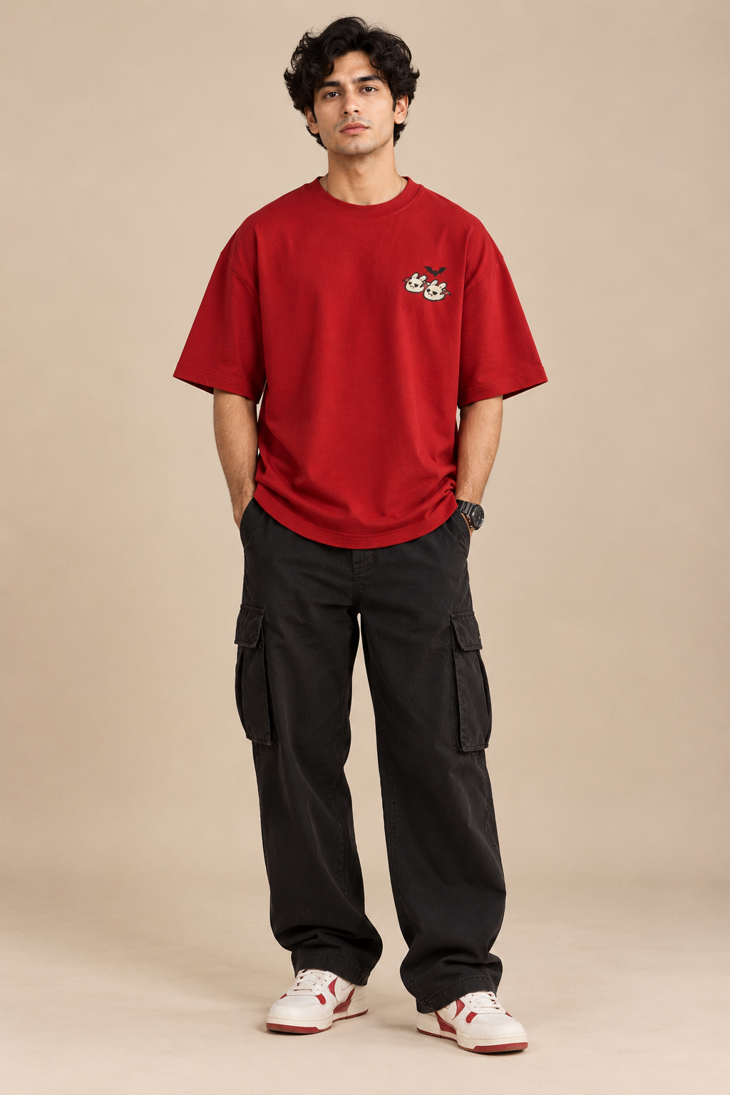 Red oversized Halloween T-shirt with a small cute ghost and bunny graphic and a black bat on the chest styled with baggy pants