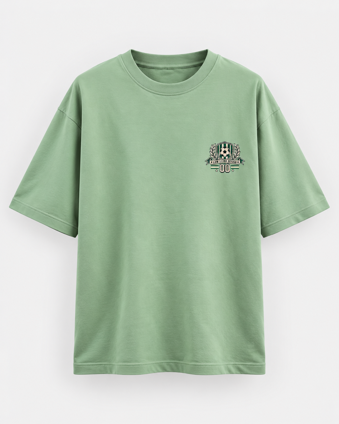 Jade green oversized football T-shirt with a small green and cream soccer crest graphic on the chest.