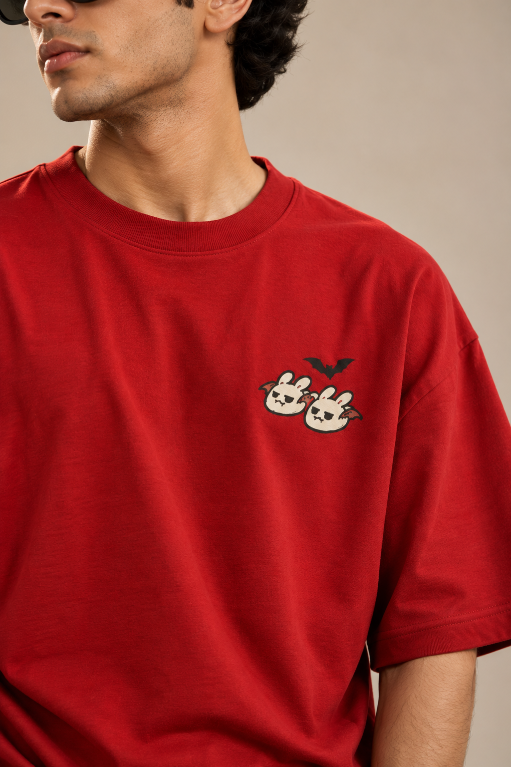 Red oversized Halloween T-shirt with a small cute ghost and bunny graphic and a black bat on the chest.