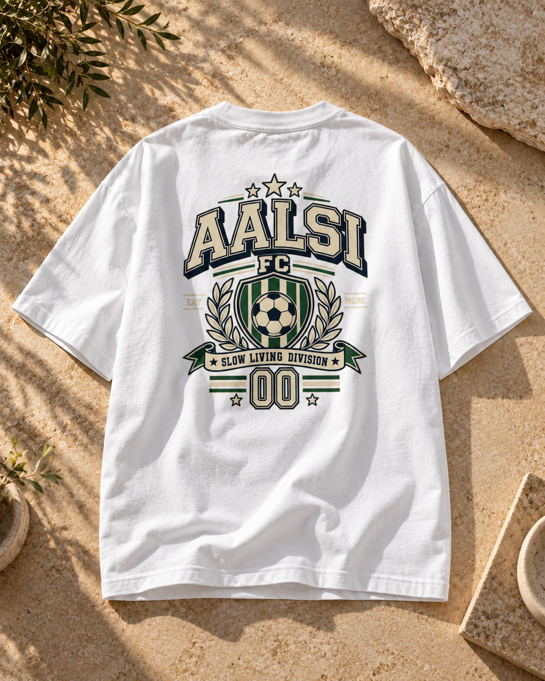 Back of a white Aalsi FC oversized T-shirt featuring a large varsity football crest, soccer ball, laurel graphics and Slow Living Division slogan.